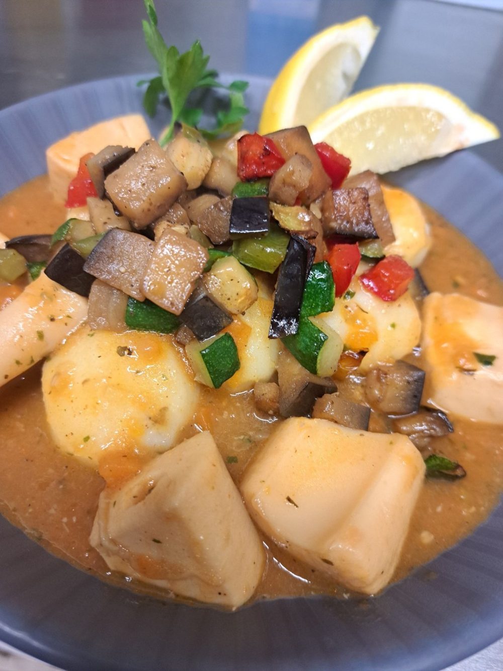 Un plat mijoté de légumes et de pommes de terre, avec une tranche de citron